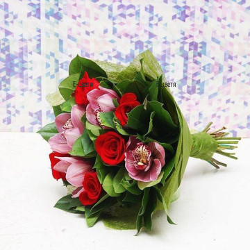 Lovely bouquet of exotic orchids and classic red roses, complemented by greenery.