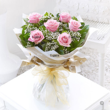 Classic bouquet of pink roses, complemented with greenery and gypsophila, finished with luxury wrapping.