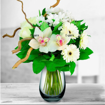 Tender, elegant bouquet of white flowers - orchids, roses, chrysanthemums, gerberas, fresh greenery and decoration.
