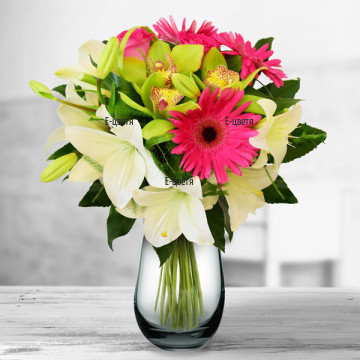 A charming bouquet of fresh flowers - orchids, gerberas, lilies, in gentle mellow colours, wrap and arranged  with fresh greeneries