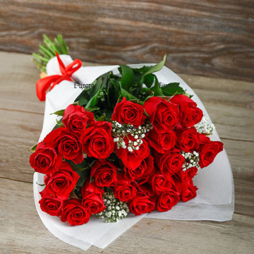 Passionate, loving red roses, arranged with delicate, white gypsophila, greenery and beautiful wrapping - perfect gift for romantic anniversary.
