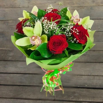 Classic red roses and exotic orchids, put in ampules, wrapped in a lot of greenery.