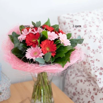 Lovely bouquet of red and pink gerberas, fresh greenery and impressive wrapping.