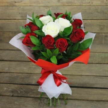 Classic bouquet of roses in two colours - passionate red and delicate white, arranged with plenty of fresh greenery and wrapping.