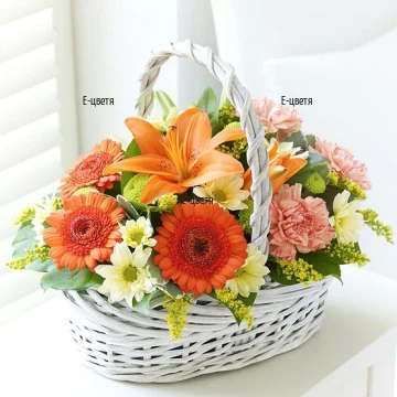 Lovely, vibrant basket with flowers in bright hues - lilies, gerberas, chrysanthemums and plenty of greenery.