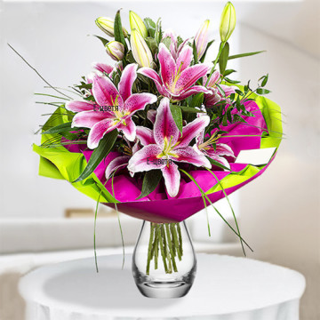 Artful bouquet of lovely, delicate lilies, arranged with abundant greenery and double layer wrapping.