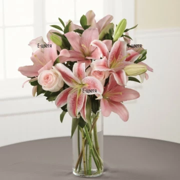 Tender combination of lilies and roses ind soft pink hues, wrapped in a lot of greenery.