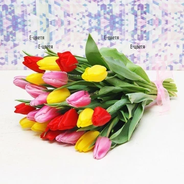 A bouquet of multicoloured tulips, tied wit a ribbon.