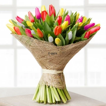 A bouquet of colourful tulips, wrapped in luxury paper