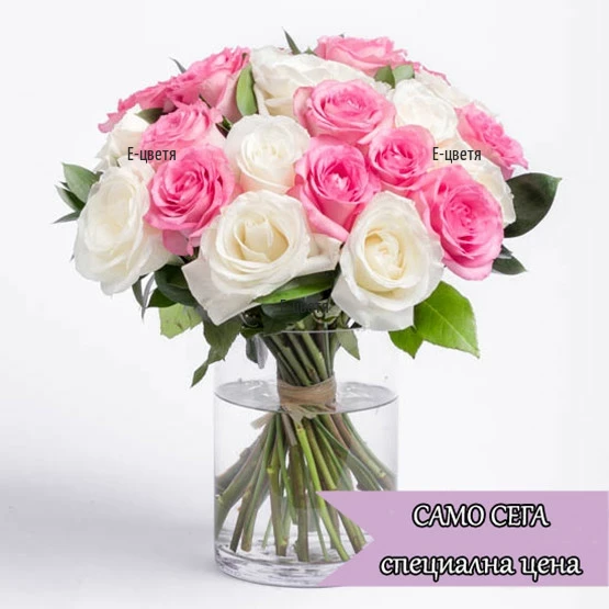 A bouquet of pink and white roses, tied with a ribbon