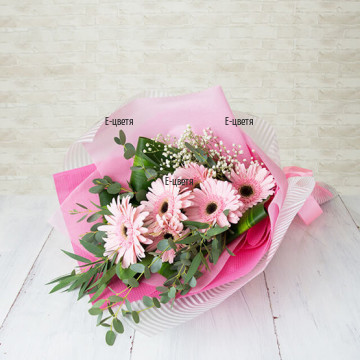 An online order of flowers - beautiful, tender bouquet of pink gerberas and greenery. Delight your beloved one with this wonderful gift.