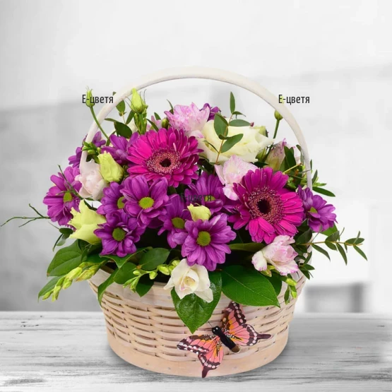 Gentle basket arranged with flowers in mellow colours
