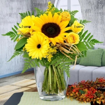 Summer bouquet - a mix of sunflowers, roses and gerberas, wrapped in a lot of greenery and decoration.