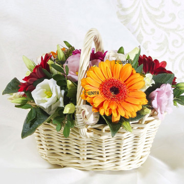 Colourful basket with a variety of flowers, fresh greens and much positive emotions.