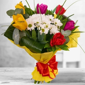 A beautiful mix of fragrant tulips in a variety of fresh colors and dainty white chrysanthemums, liberally garnished with sizzling Dutch greens.