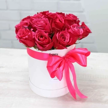 A delicate arrangement that will charm any lady! Beautiful satin-like pink roses arranged in a modern flower box and tied with a large ribbon.