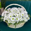 Basket with white chrysanthemums and greens