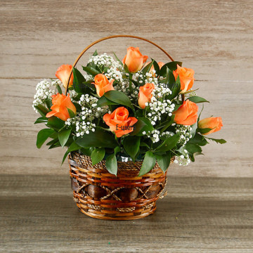 Gorgeous, vivid basket, arranged with sunny orange roses, delicate white gypsophila and a lot of greenery.