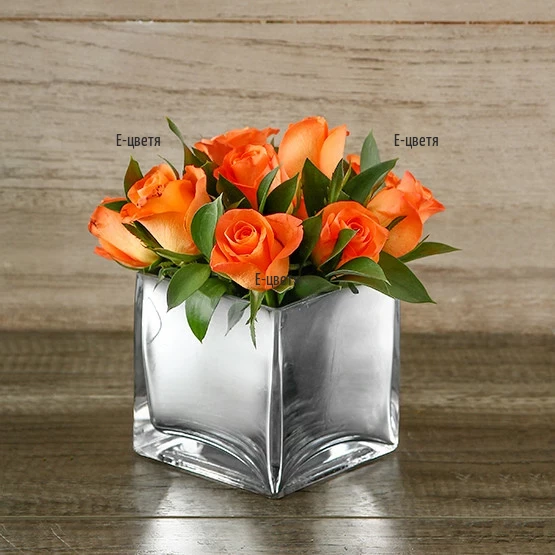 Send nice arrangement with roses in glass cube.
