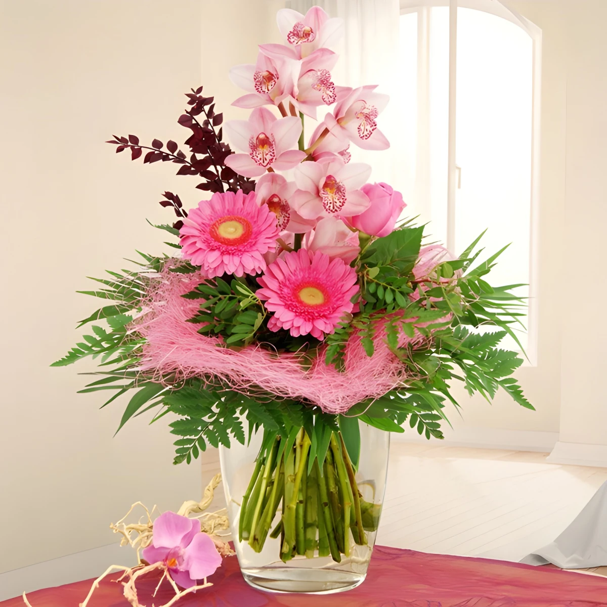 Send a bouquet of pink Cymbidium orchid and roses.