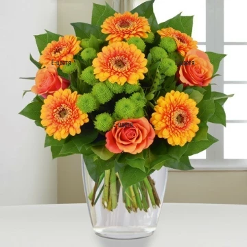 Luxuriant bouquet of mixed flowers and greenery. Artful, modern composition of bright coloures and soft green hues.
