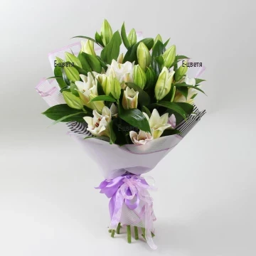 Original, impressive, exotic bouquet of gentle white lilies, arranged with greenery.