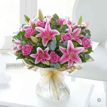 Impressive, extraordinary, luxuriant bouquet of flowers in pink hues and plenty of greenery, wrapped in classic gift paper.
