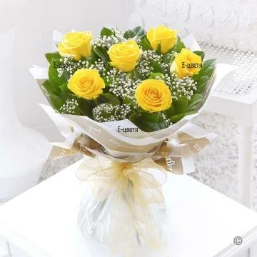 Bright, cheerful bouquet of yellow roses, white gypsopfila and lush folliage. The yellow roses are the symbol of friendship, of mutual assistance.