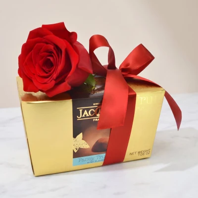 Delicious, chocolate truffles and one red roses, symbol of love, appreciation, gratitude and devotion.