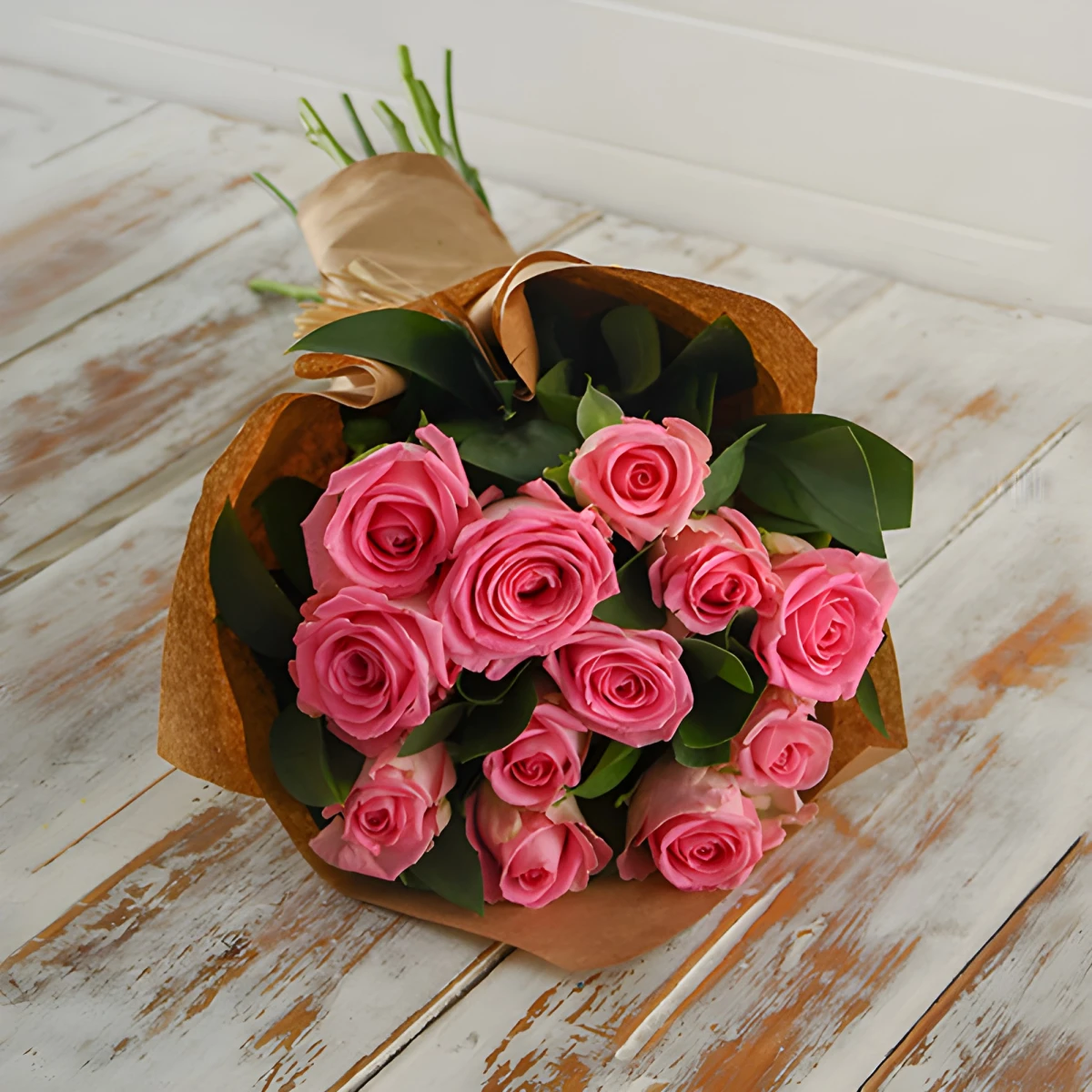 Send a bouquet of pink roses and gift paper.