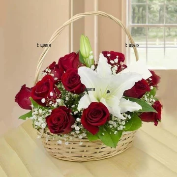 Romantic, modern basket, arranged with red roses and white lilies - the passion and the tenderness.