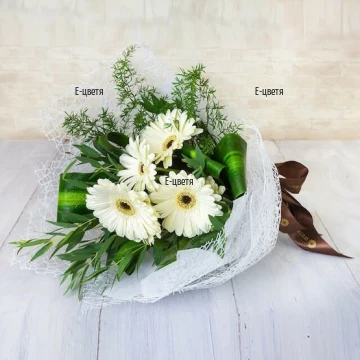 We offer to your attention a beautiful and delicate bouquet of white gerberas and fresh greenery, arranged in a bouquet with suitable packaging.