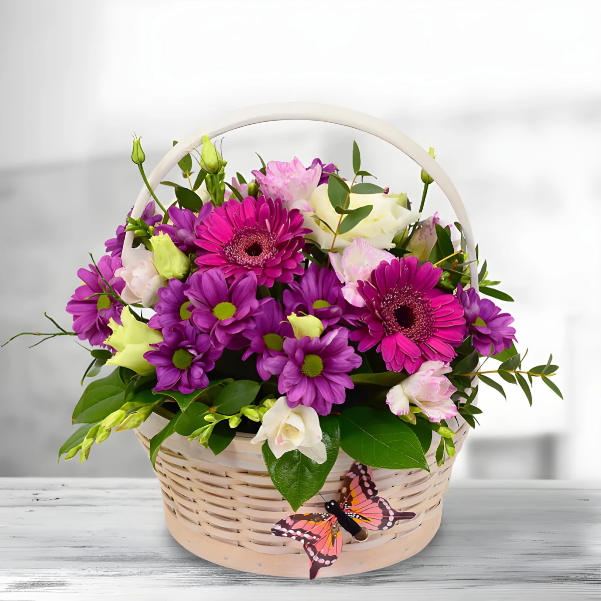 Gentle basket arranged with flowers in mellow colours