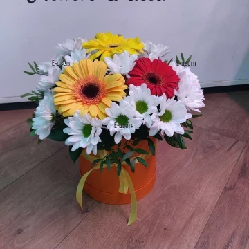 Beautiful composition of various flowers and greenery, arranged in a special flower box with piaflora, preserving their freshness for a long time.