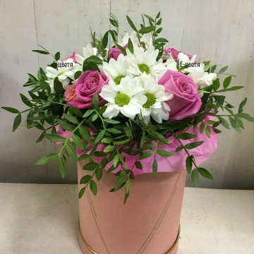 A beautiful box with a mix of flowers and greens