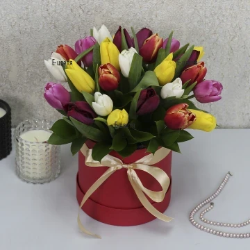 Bright, multicolored tulips – a symbol of spring – beautifully arranged in a special box, making a wonderful and fresh gift for March 8th.