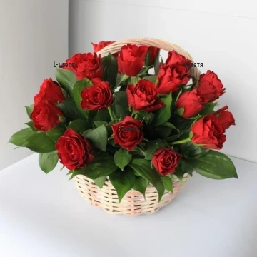 A basket with 21 red roses and greenery.